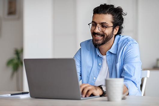 Smiling Boy working on Laptop